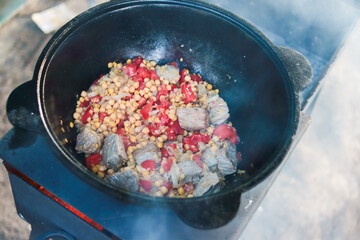 Khusnut. Cooking in a cauldron. Food on the grill. Close-up. Selective focus. Copyspace