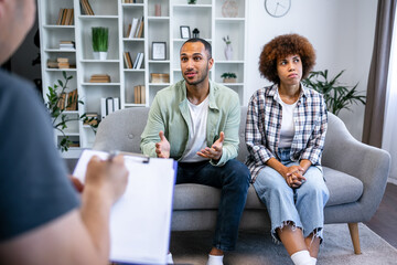 Fototapeta premium Effective marital therapy. couple sitting on couch at counselor's office