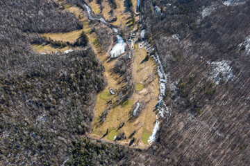 Winter aerial view of Barrie golf course, Ontario, showcasing serene snow patches, greens and...