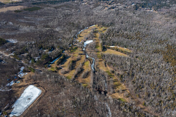 Winter aerial view of Barrie golf course, Ontario, showcasing serene snow patches, greens and...