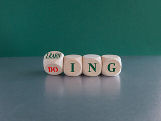 Learning by doing concept. Turned a dice and changes the word learning to doing, or vice versa....