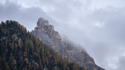 Mountain peak shrouded in fog during autumn season, Italy, Europe