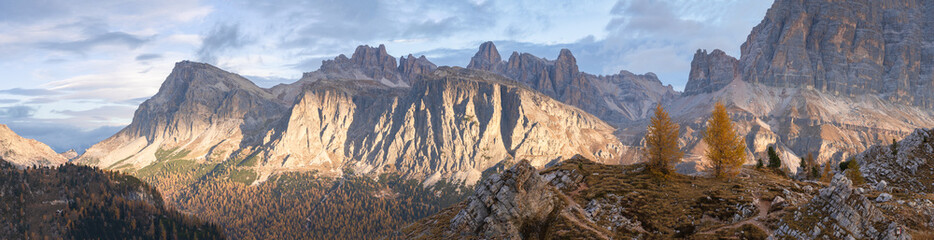 Fototapeta premium Colorful autumn alpine panoramic landscape with mountains and golden larches , Italy, Europe