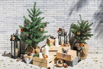 Christmas tree and gifts on the background of a brick wall with copy space