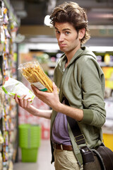 Man, portrait and product comparison in supermarket question, choice or label difference. Male...