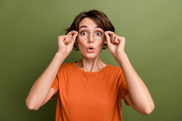 Photo of young funny woman bob brown hair pouted lips unexpected holding specs cant believe her eyes isolated on khaki color background - obrazy, fototapety, plakaty