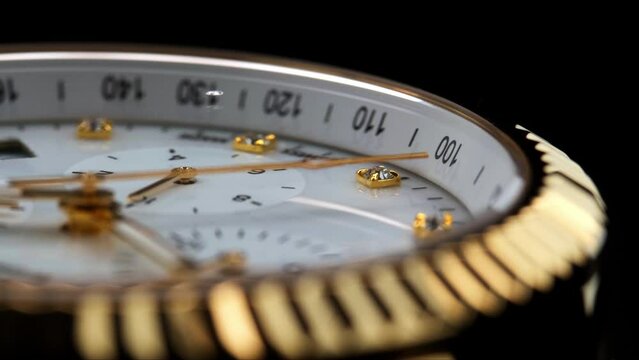 Close Up Of Stylish Luxury Man Wrist Watch With Moving Hand And Multiple Dials. Men's chronograph watch in metal with sapphire crystal. closeup view of rotating watch, running second arrow. white dial