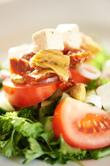 Background, closeup and plate of healthy salad, food and nutrition for detox, lunch diet and eating in cafe. Appetizer, vegan cuisine or dining in restaurant for meal of leafy greens, tomato and feta