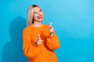 Portrait of funky cheerful woman with bob hairdo dressed knitwear sweater directing at you winking...