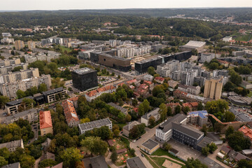 Fototapeta na wymiar Drone photography of old and new multistory apartment complex with trees and lots of greenery