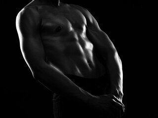 Silhouette of a slender muscular man doing sports in the gym. Sports and healthy lifestyle. - obrazy, fototapety, plakaty