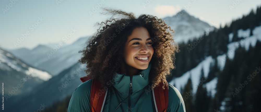 Poster brunette curly haired woman hiking in snowy mountains