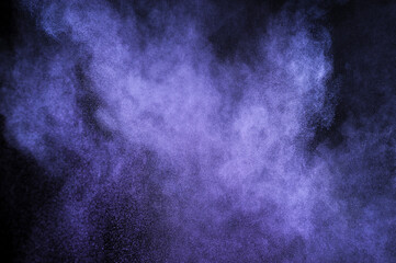 Purple powder explosion on black background. Mauve color cloud. Violet dust explode. Freeze motion...