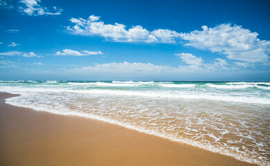 Fototapeta na wymiar Yellow sand beach, sea and deep blue sky..