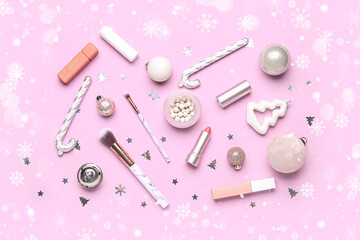Makeup products with Christmas decor on pink background