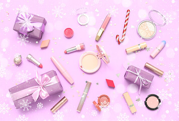 Makeup products with Christmas gifts on lilac background