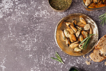 Plate with pickled mussels on dark background