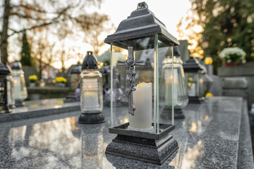 Fototapeta na wymiar Candle lights at the cemetery at night in Poland during All Saints Day