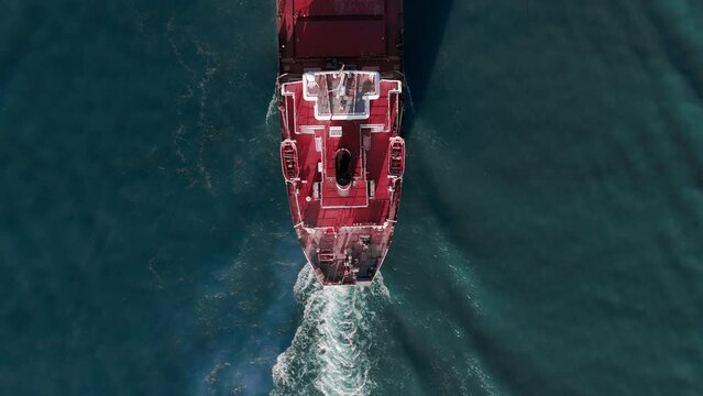 Aerial top down shot of cargo Bulk carrier ship cruising. Zoom top down shot