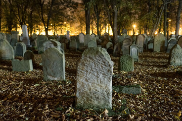 Tombstones in an old cemetery at night.  - 664050337