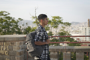 Young international student with backpack walking on campus..