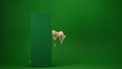 Green screen isolated chroma key photo capturing a mummy showing from behind a green screen banner box, booing and scaring somebody. Full length.