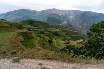Fototapeta na wymiar Chokhsky terraces Dagestan. Landscape of mountainous Dagestan with terraced fields and peaks mountains in the distance.