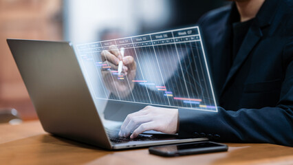 Businessman checks and manages his weekly schedule on a laptop