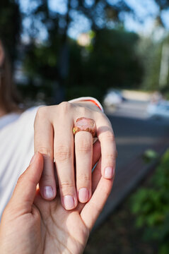 Wooden ring made of epoxy resin on a girl's hand. Women's jewelry made from natural materials.