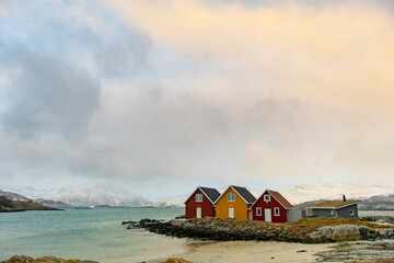 Fototapeta na wymiar Winter Norway landscape with rorbu on the ocean beach and snow