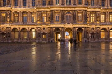 Louvre Museum, Paris, France. Palace Court Square on a rainy late afternoon.