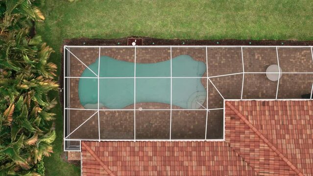 Aerial Above view of screened in pool and lanai in florida house. Top down shot