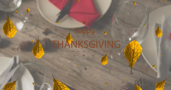 Animation of happy thanksgiving over autumn leaves and place setting on wooden background
