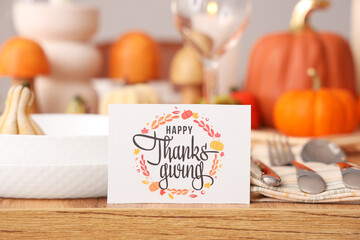 Naklejka na ściany i meble Greeting card with text HAPPY THANKSGIVING on served dining table, closeup