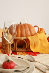 Festive table setting for Thanksgiving Day with pumpkins, napkins and cutlery