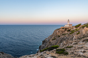 Fototapeta na wymiar Capdepera Lighthouse at the beautiful coast with the Mediterranean Sea and stunning cliffs of Cala Ratjada on Majorca Island, Spain