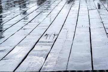 wet boards of a wooden sidewalk during the rain