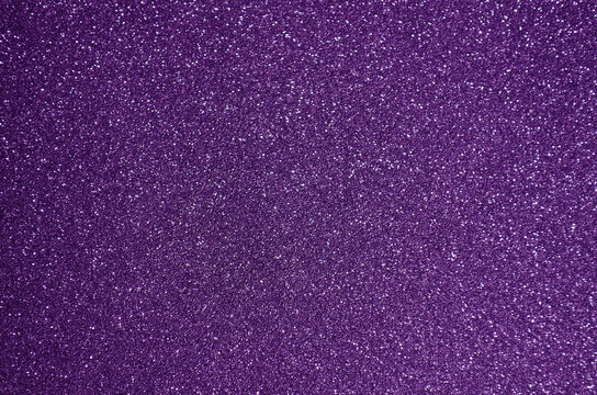 Fondo de brillos / textura glitter de color violeta/morado. Se puede usar como fondo de celebraci&oacute;n, fiesta.