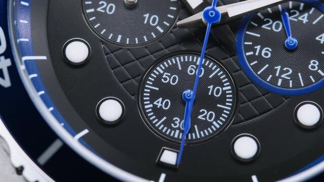 Close Up Of Stylish Luxury Man Wrist Watch With Moving Hand And Multiple Dials. Men's Swiss chronograph watch in metal with sapphire crystal. closeup view of rotating watch , running second arrow