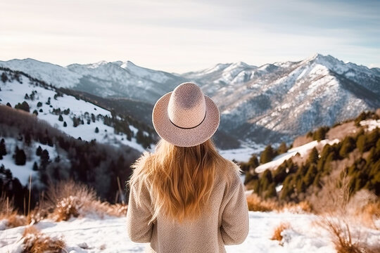 A woman standing on a snow-covered slope wearing a stylish hat