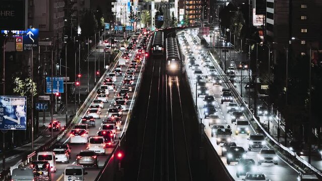 Car traffic transportation on elevated highway road, commuter subway train on railroad track at night in Japan. Japanese people lifestyle, Asia transport culture, Asian city life concept