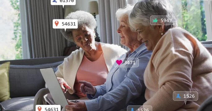 Animation of social media icons and numbers over senior diverse female friends with laptop at home