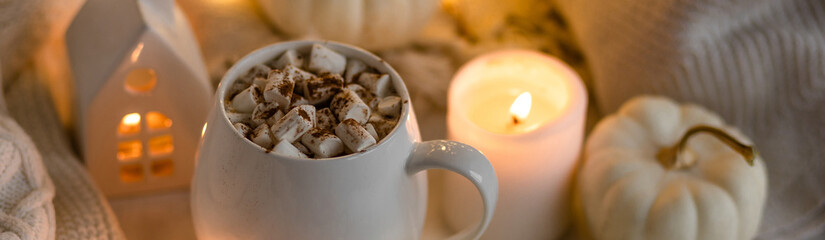 White mug with aromatic autumn hot drink - sweet delicious pumpkin latte with marshmallow and...