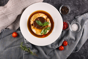 Potato with meat, sauce and vegetables