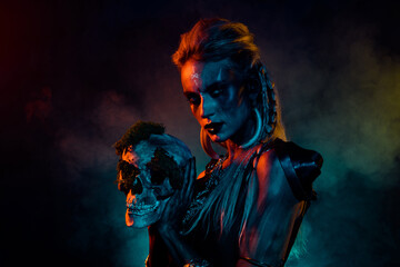 Obraz premium Photo of dangerous wild mysterious lady wear viking clothes holding dead person head isolated dark smoke background