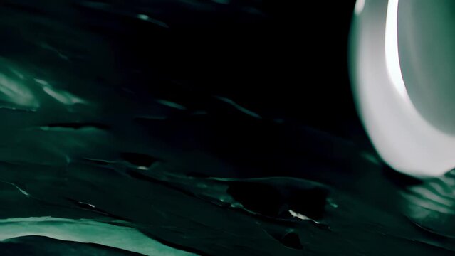 Texture of polished granite with a striking emerald green color, showcasing a rous and luxurious surface with a subtle sheen.