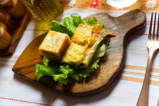 Flija - baked puff pastry with cream or cheese. Served on a lettuce leaf. Albanian or Kosovo cuisine