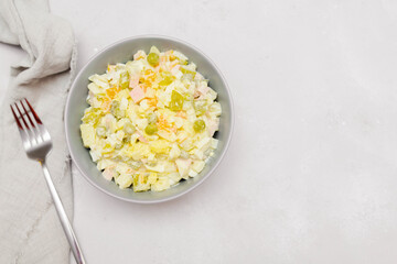 Olivier salad,Christmas food.salad with chicken and vegetables,pea.Traditional ukrainian slavic appetizer for celebrating new year's eve. Festive table setting