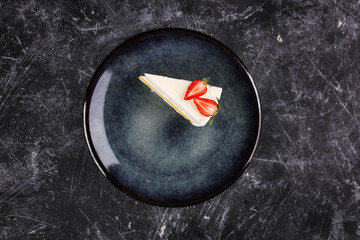cheesecake cake with strawberries on a dark background.