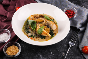 Chicken fillet with spinach and sun-dried tomatoes in coconut milk.
